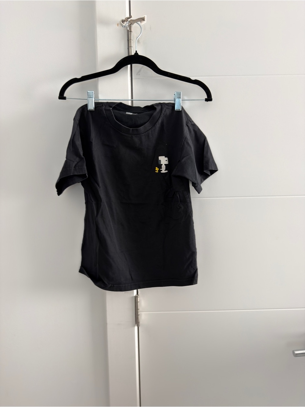 Uniqlo Black Short Sleeve Tee with Small White & Yellow Graphic